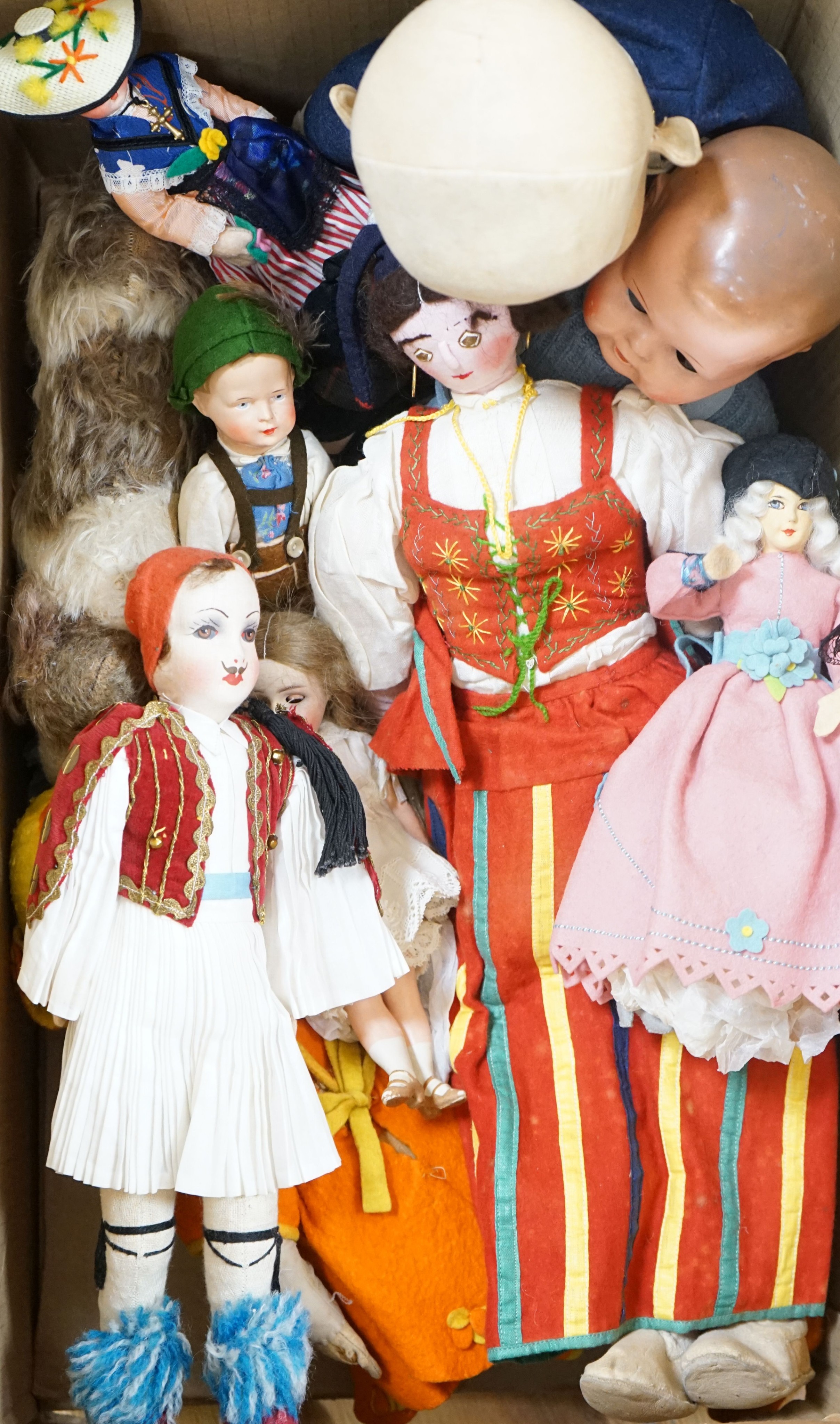 A collection of dolls and two soft toys